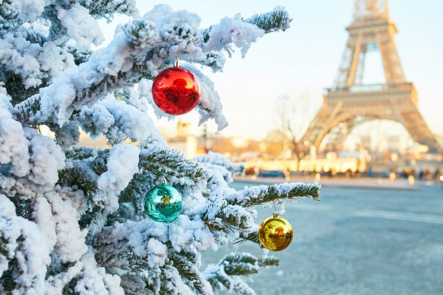 A white Christmas tree in Paris with the Eiffel tower in the background