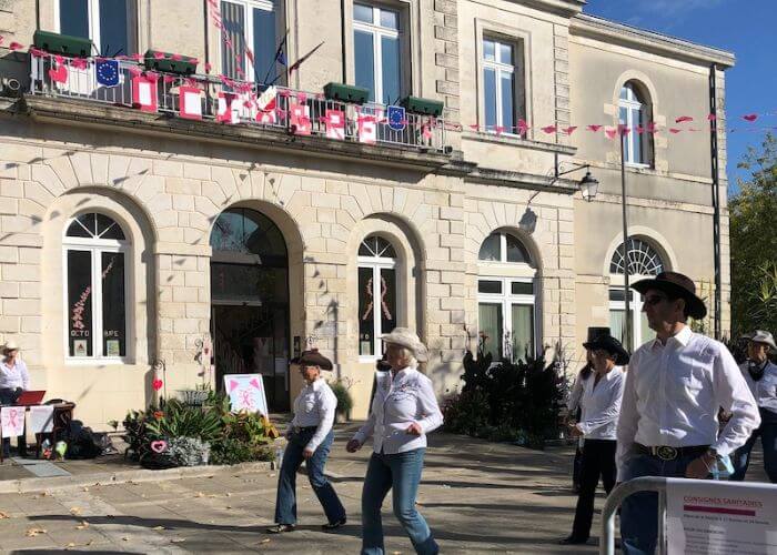 People line dancing outside the Marie Town Hall in France