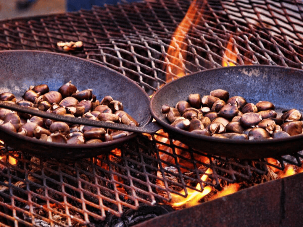 Chestnuts roasting on a grill over a fire