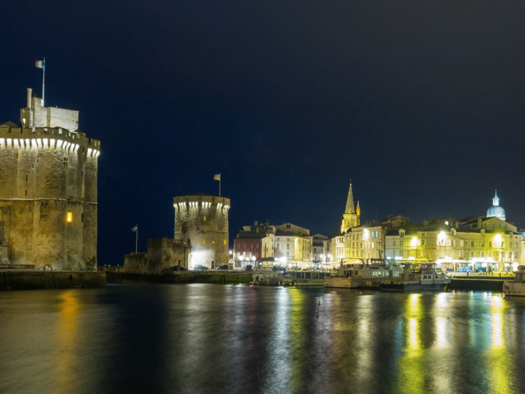 A town set by the water at night with old buildings