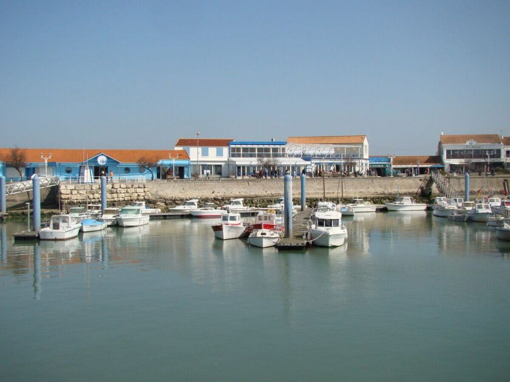 A stretch of water with fishing boards and restaurants in a harbour you can see in a weekend in Ile d'Oleron