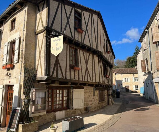 Old timbered building with a restaurant sign outside