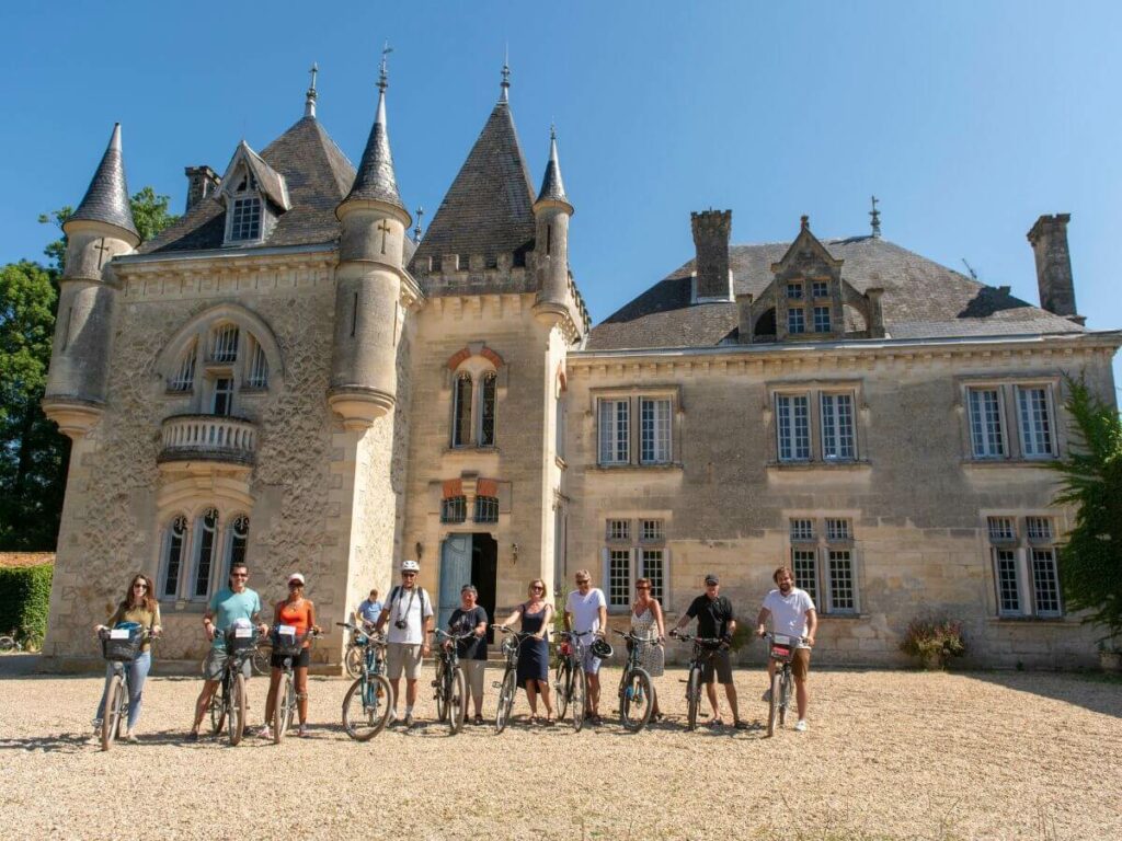 A group of people stood outside a chateau near Bordeaux