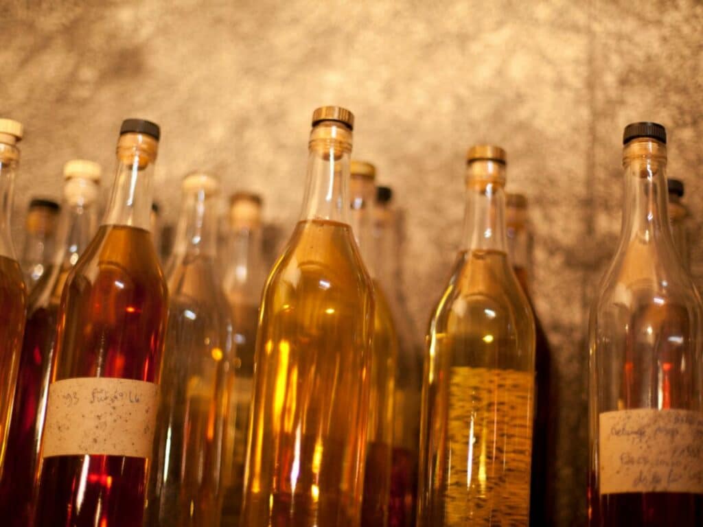 A collection of wine bottles containing pineau des charentes