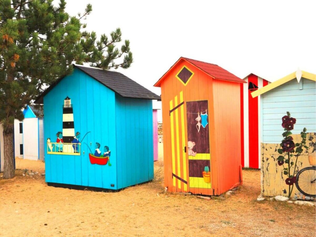 Brighlty coloured blue and orange beach huts