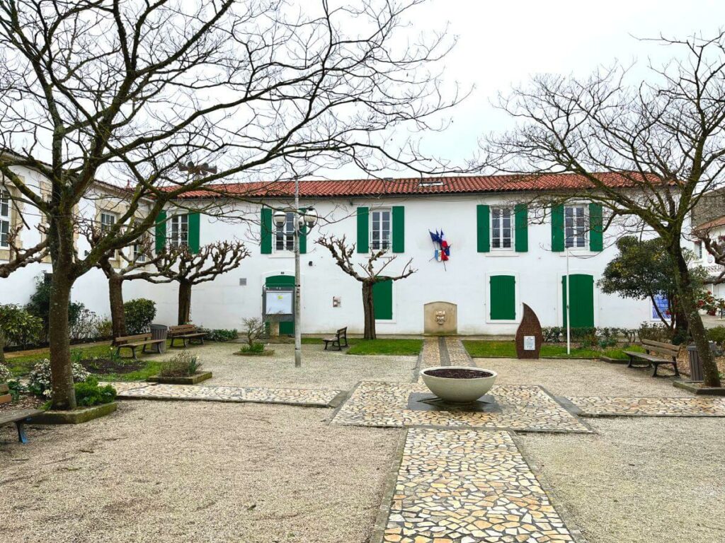 A whitewashed building with green shutters in Saint-Pierre