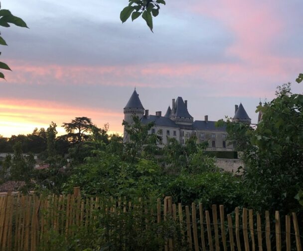 A Chateau set against the sunset in a French village