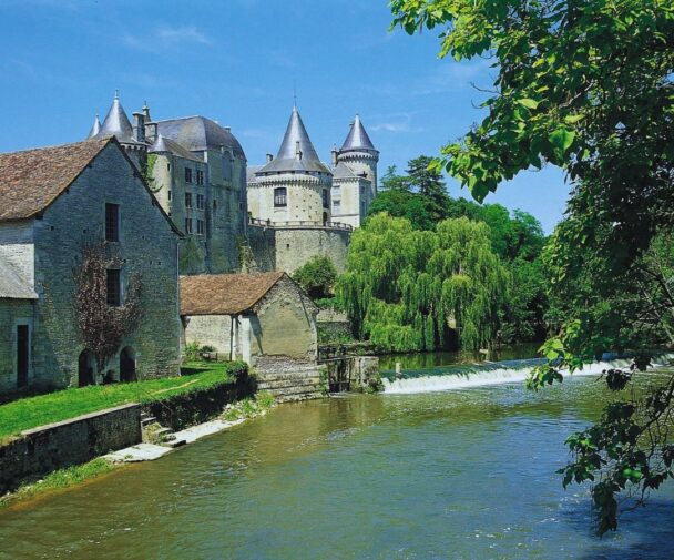 A castle and old buildings by the Charente river in France