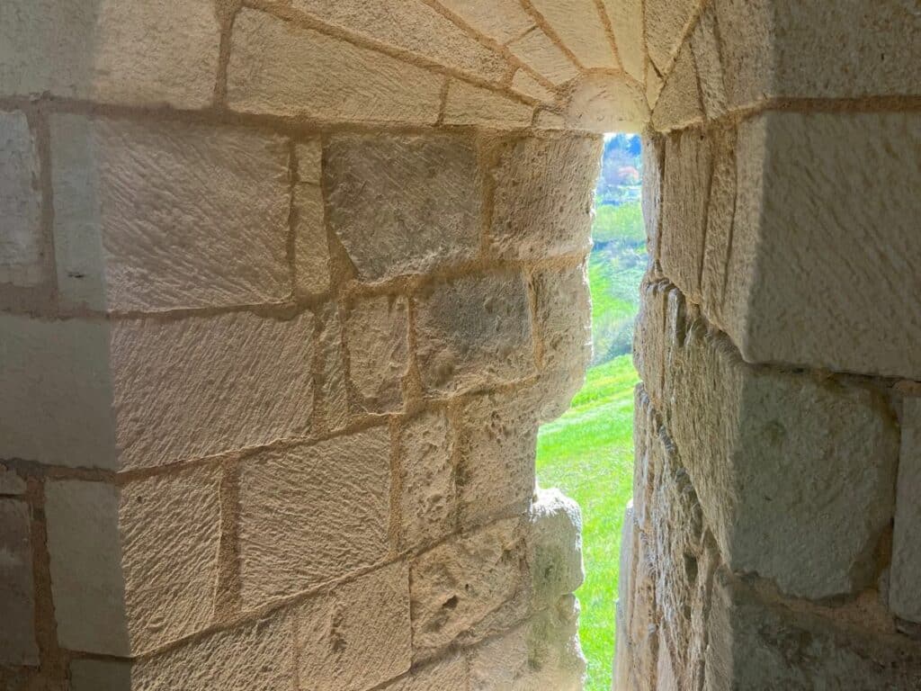 An arrow slit in a big thick wall at the Chateau Villebois-Lavalette