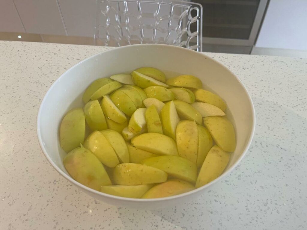 A bowl of quartered golden delicious apples