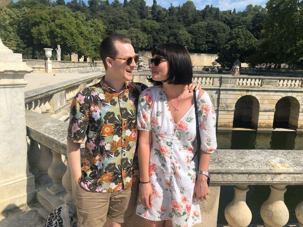 A couple standing against a stone bridge in the Charente in rural France
