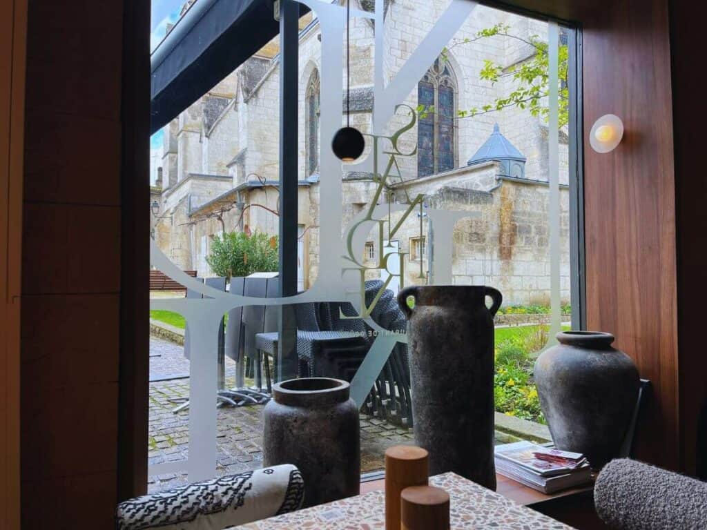 The inside of the restaurant Saint Andre in Angouleme looking out at the church
