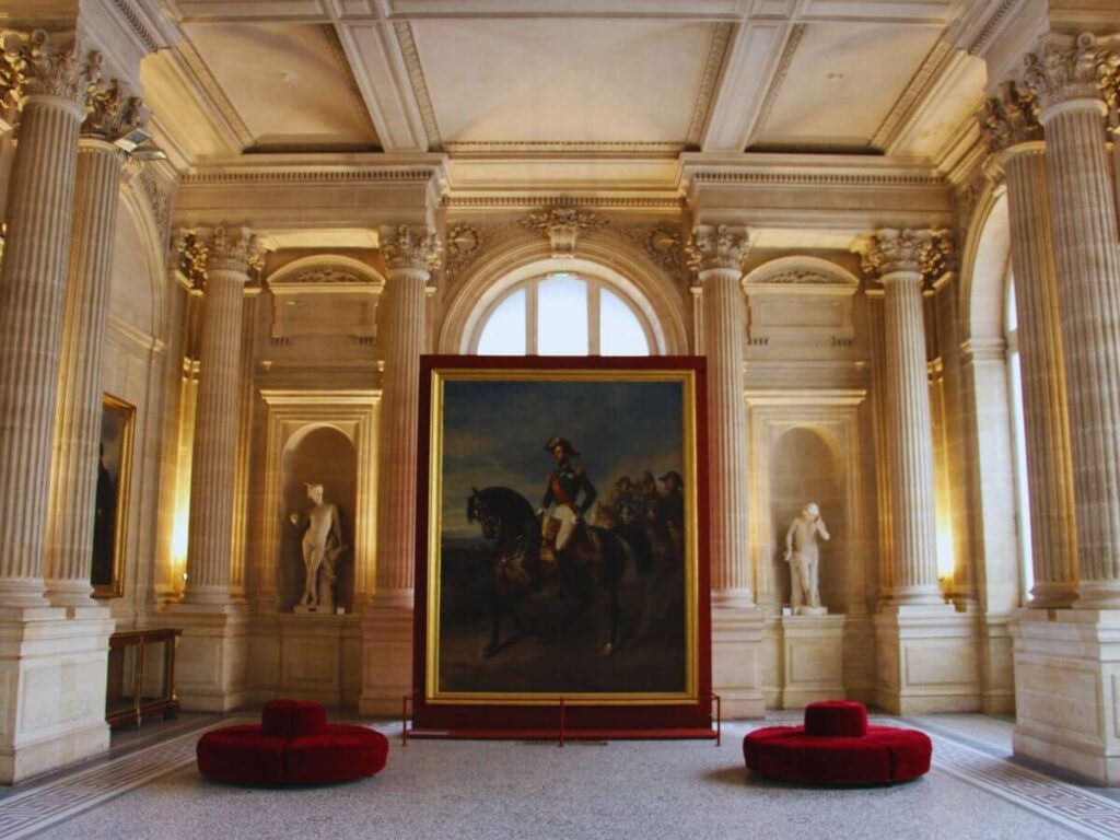 A big painting sat between two big columns inside a museum in Bordeaux