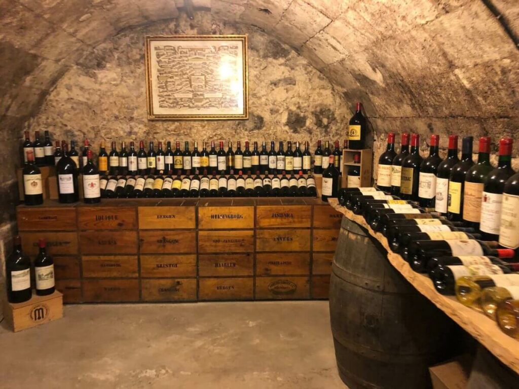 A wine cave with lots of bottles underground in a museum in Bordeaux