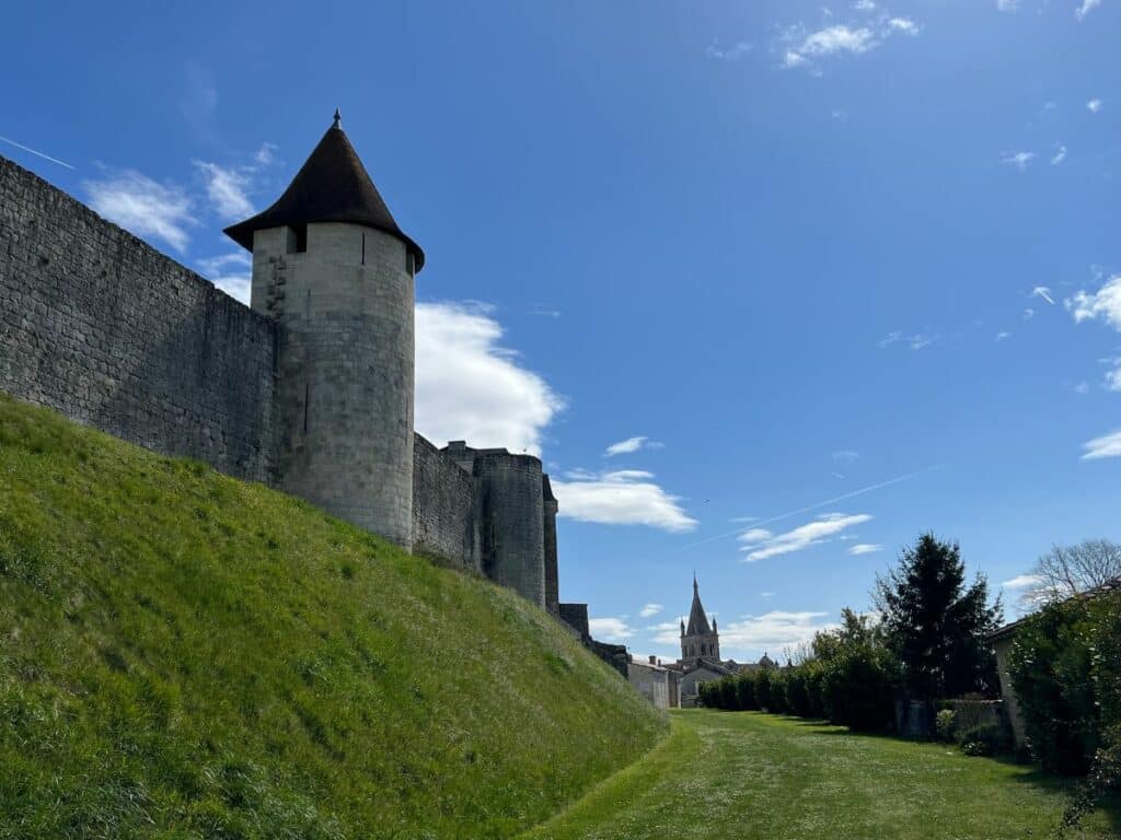 The fortified tower of the Chateau Villebois-Lavette with grass verges