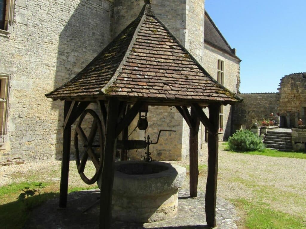 An old stone well in the grounds of the Chateau at Bayers in the Charente in France