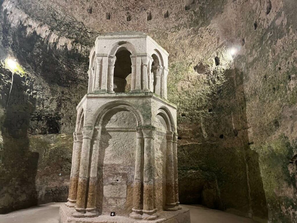 A big stone monument in an old stone cave like building in Aubeterre-sur-Dronne