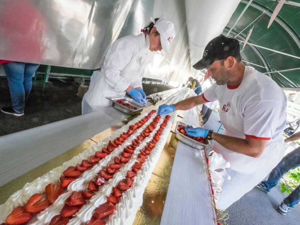 Pastry chefs making the world's longest strawberry cake at the Strawberry Festival in France