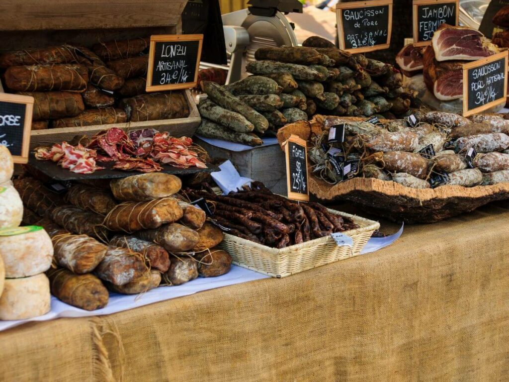 A stall at a French market with sausages