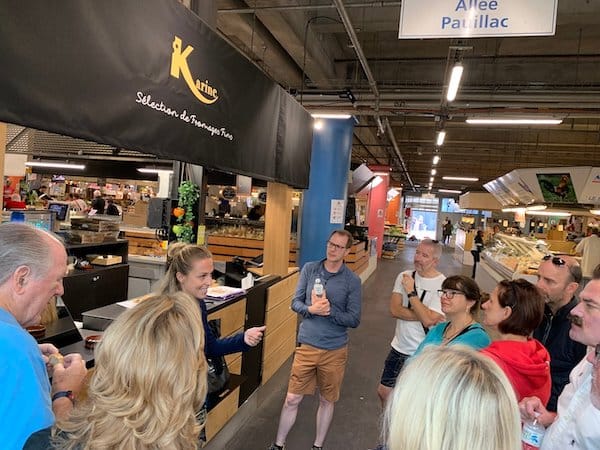 A group of people in a food market in Bordeaux