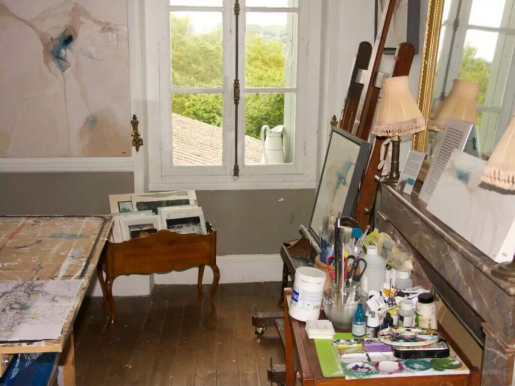 An artist's studio in France with a painting table and easel