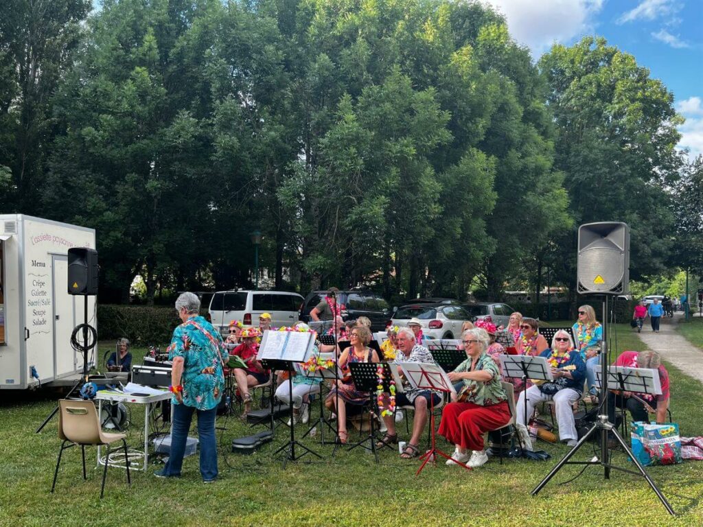 A ukelele band playing in a field at a night market in France