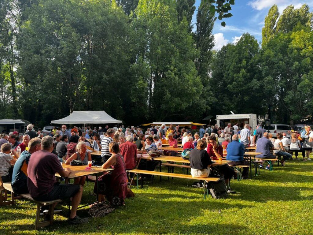 Tables and benches set up in a field for a night market in France