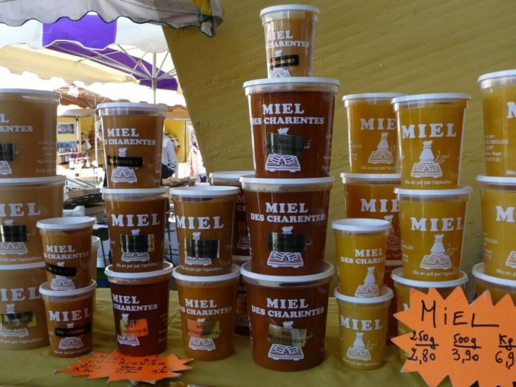 A stall selling tubs of French honey