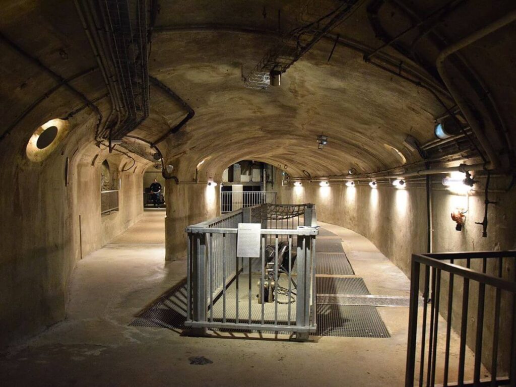 A sewere underground in Paris with railings and dimly lit