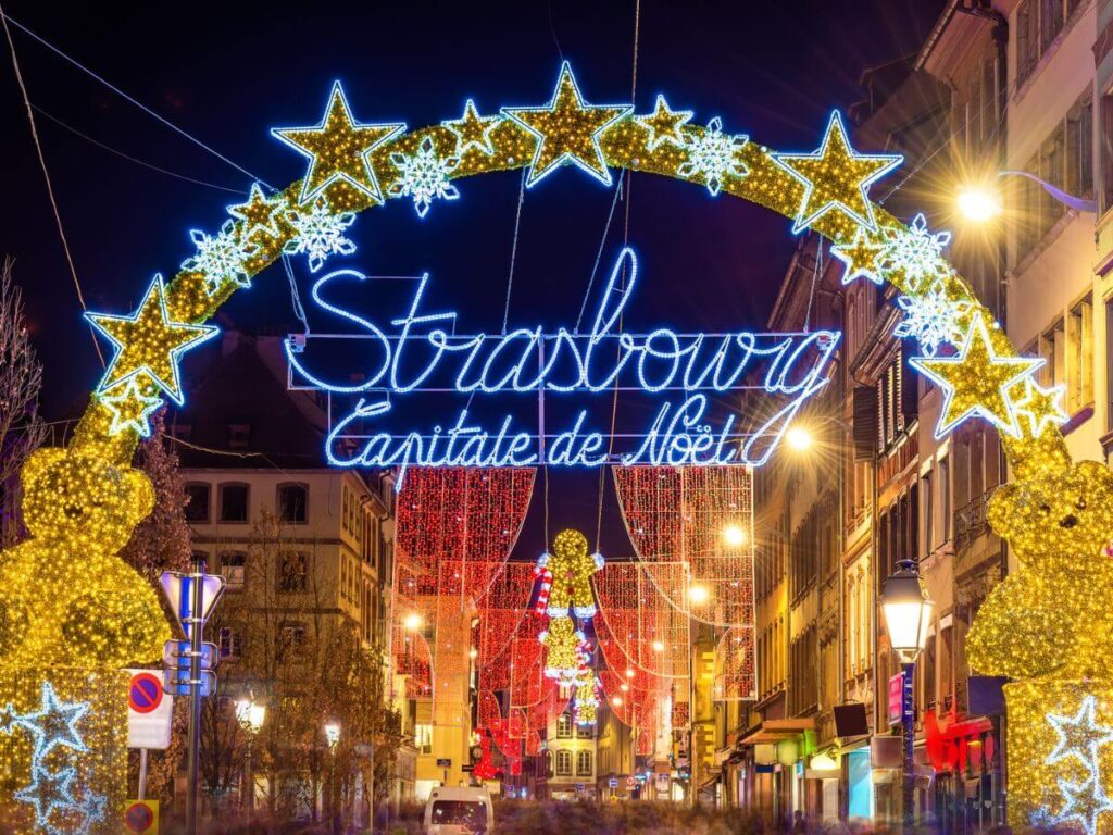 A Christmas sign lit up with stars highlighting the best Strasbourg Christmas Market