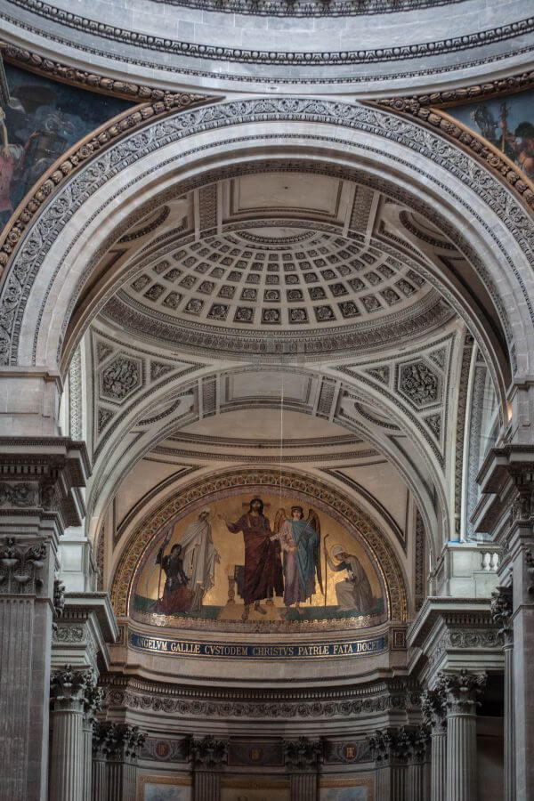 A beautiful ornate painted domed ceiling in the Pantheon building in paris