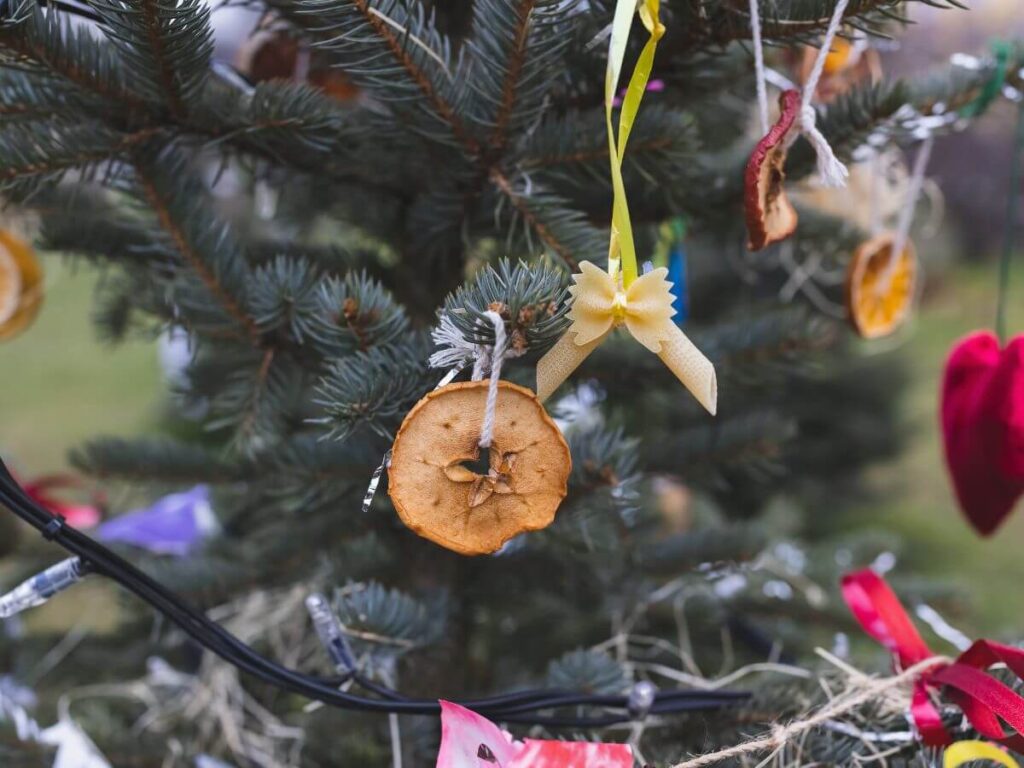 A Christmas Tree decorated with fruit and old fashioned style home made ornaments