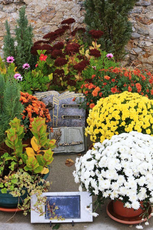 A display of chrysanthemums on a grave on All Saints Day in France
