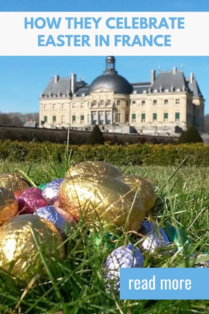 A scenic view of a grand French château with a pile of colorful, foil-wrapped Easter eggs in the foreground, symbolizing Easter egg hunts in France.