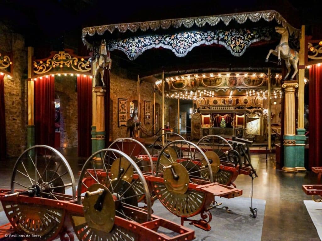 Antique carousel inside a dimly lit museum with intricate designs and vintage charm.