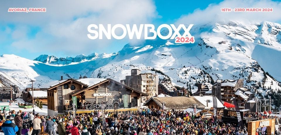 Crowded festival at Avoriaz ski resort with vibrant stage and mountain backdrop.
