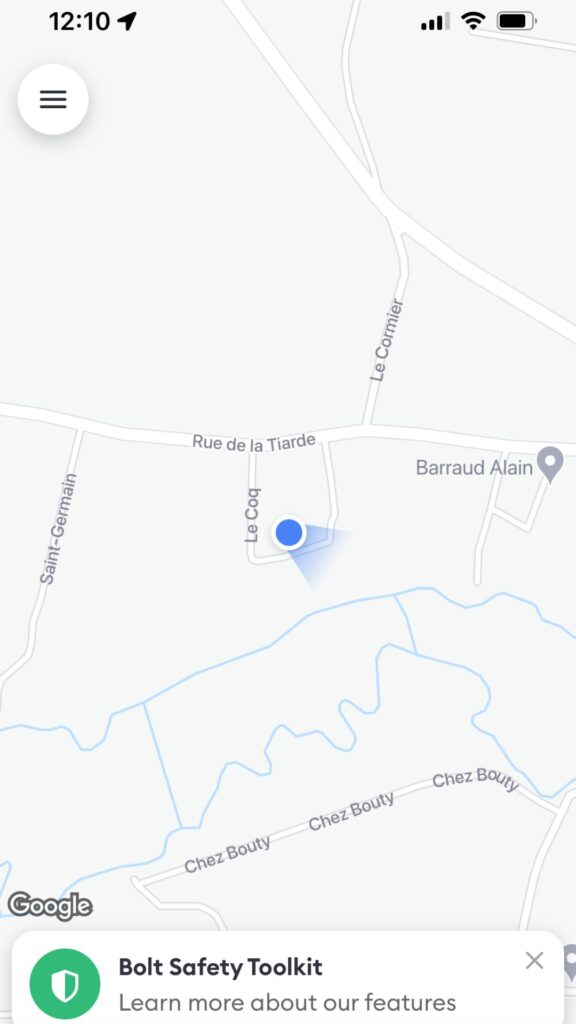 Close-up of a map app with a blue location dot and minimal details.