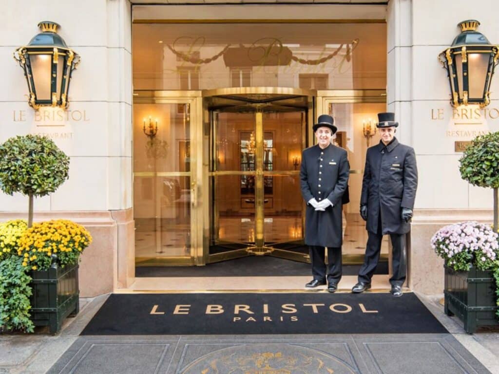 Luxury hotel entrance with uniformed staff in Paris.