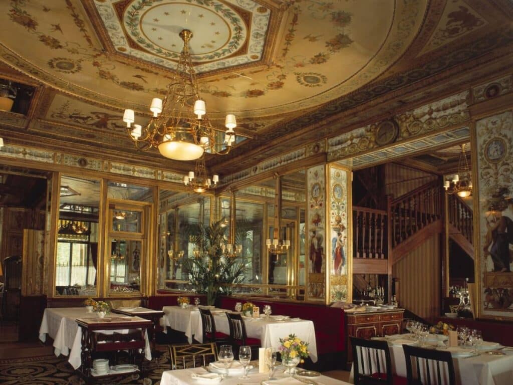 Elegant vintage restaurant interior with ornate decor.