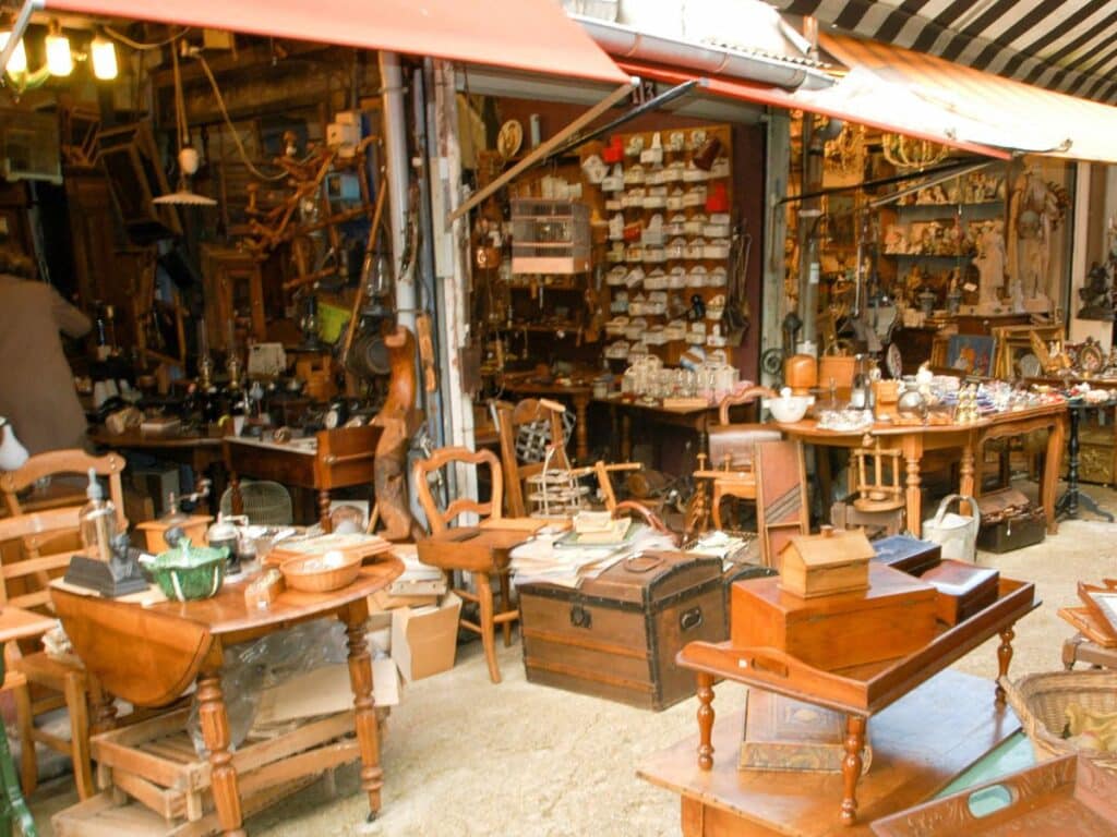 Crowded antique market with diverse collectibles.