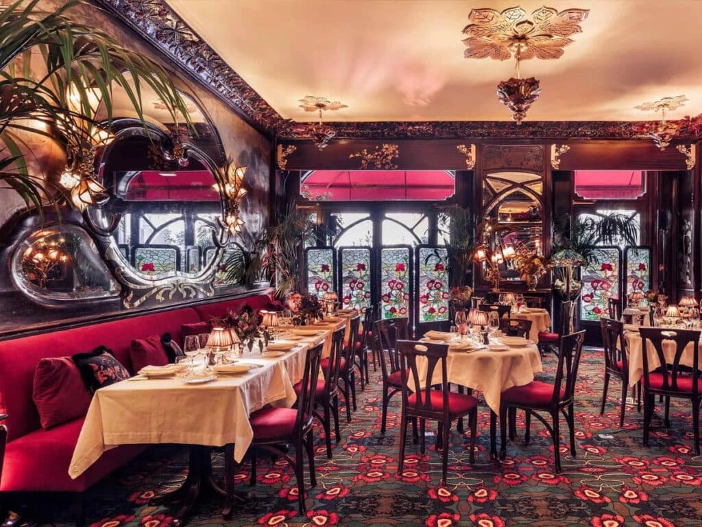 Plush interior of a vintage Parisian restaurant with Art Nouveau style.