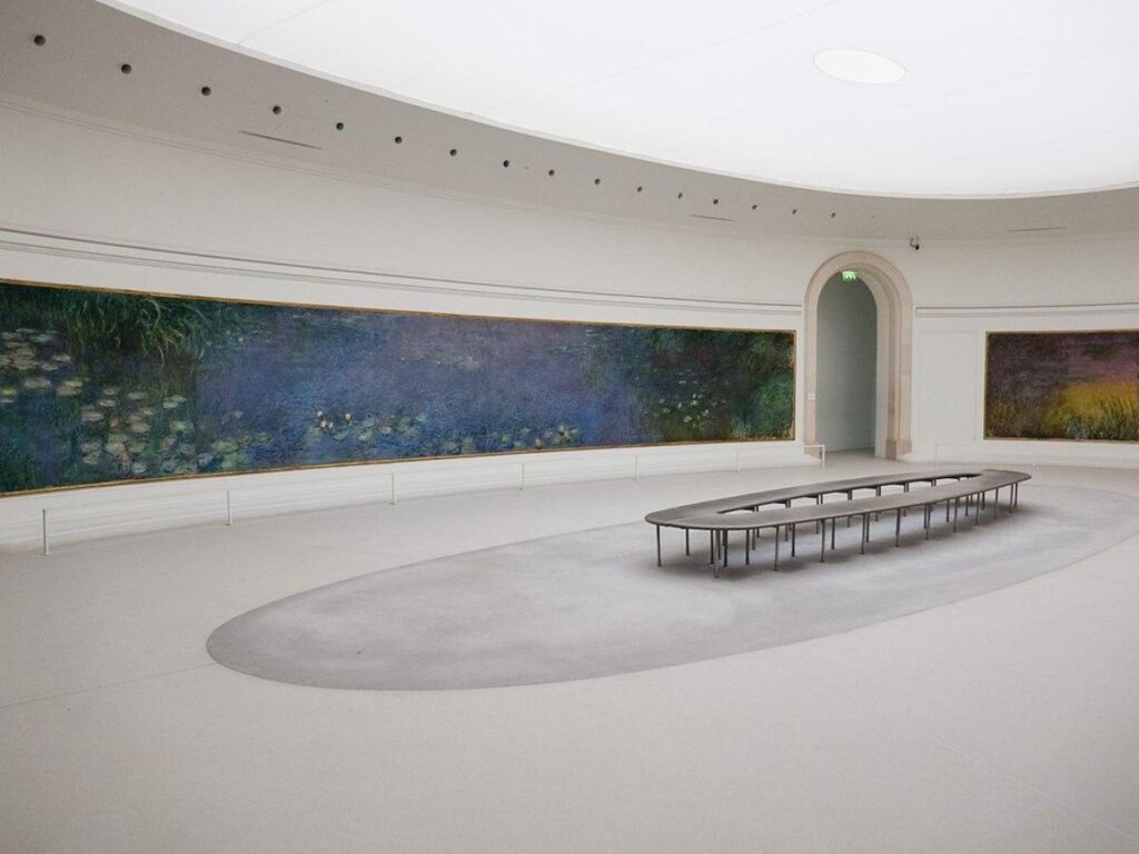 Monet's Water Lilies displayed in a serene oval room.