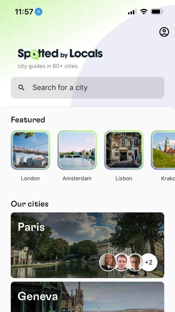 ravel app interface showcasing featured cities with local guides and images.