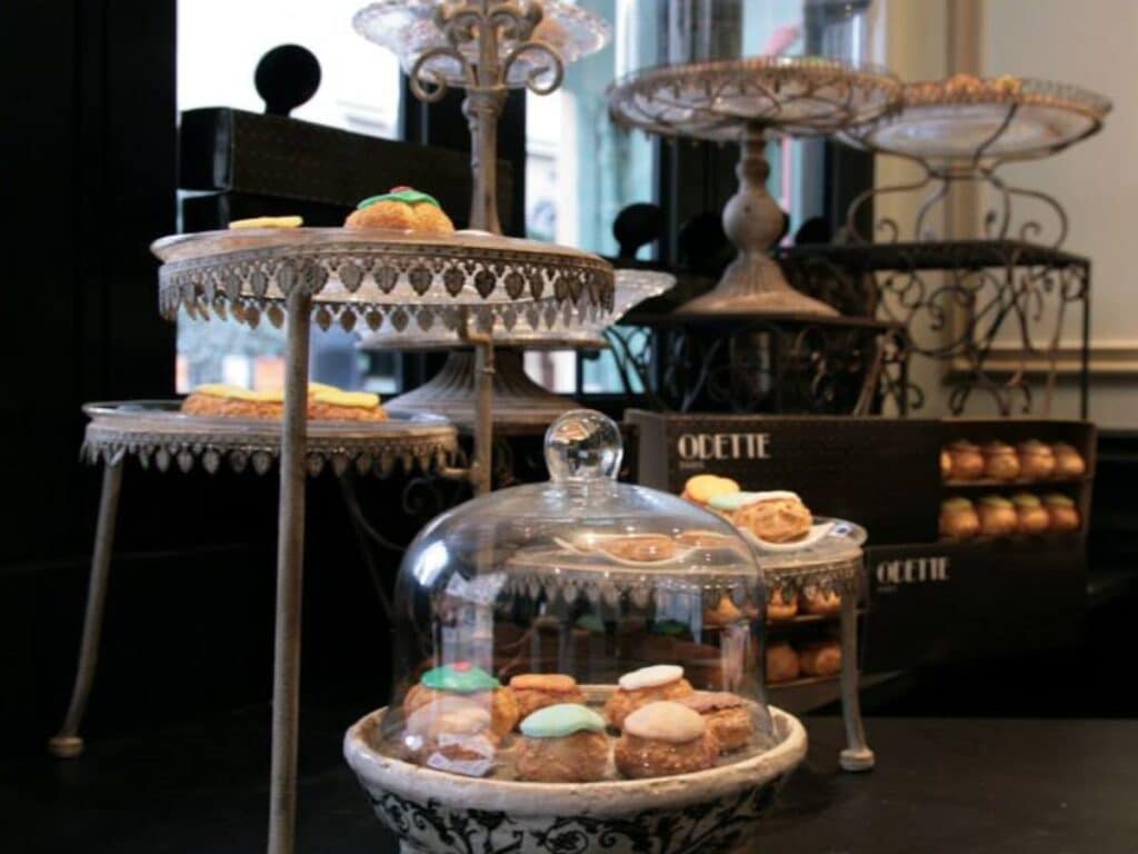 Vintage pastry stand filled with colorful French pastries.