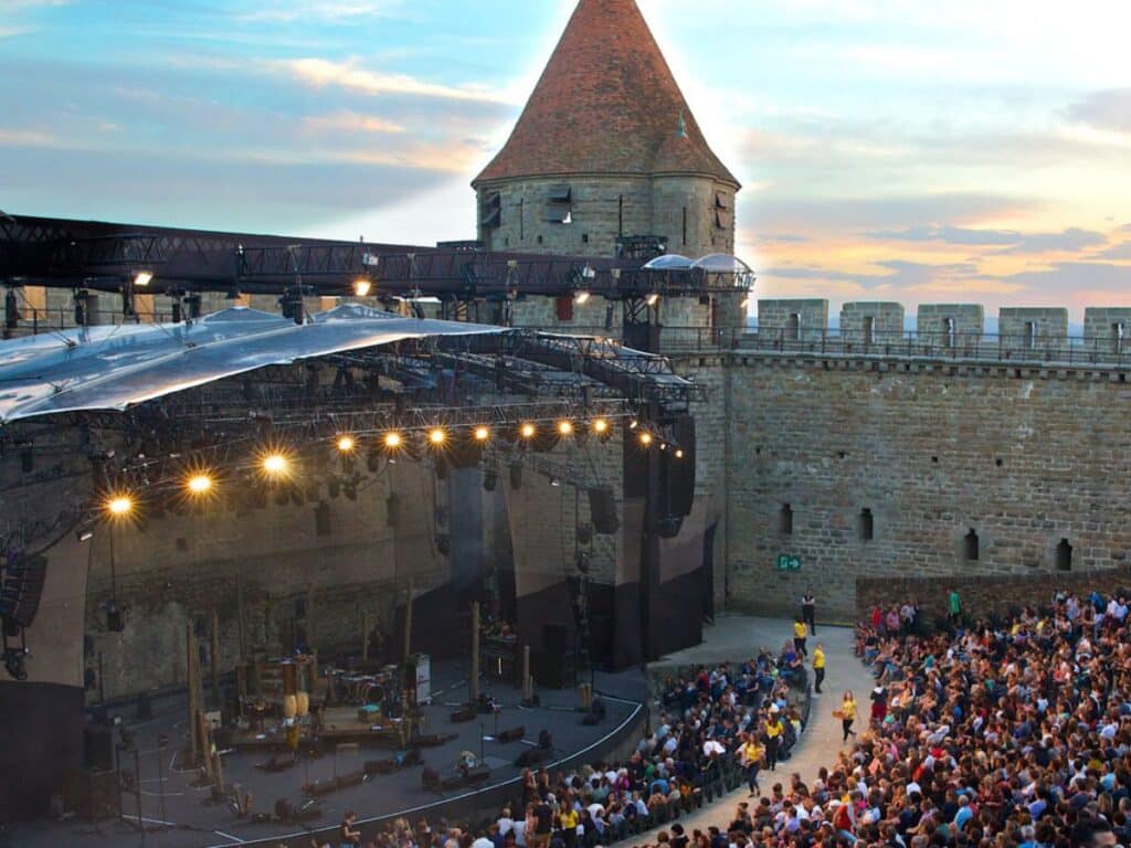 Festival de Carcassonne set against the backdrop of the castle in Carcassonne on a summer evening.