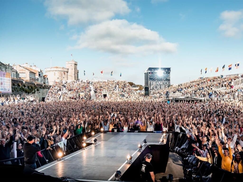Francofolies: Music Festival in La Rochelle with the towers in the background.