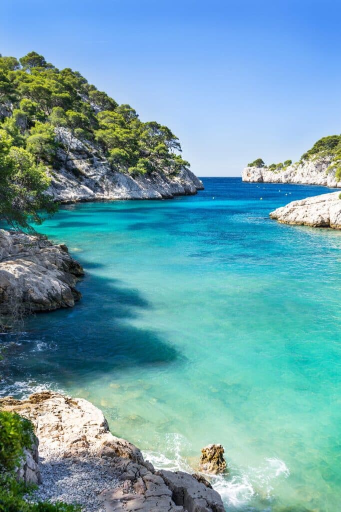 A stunning coastal cove with turquoise waters and rugged cliffs in Cassis, showcasing the natural beauty of one of the hidden gems in the South of France.