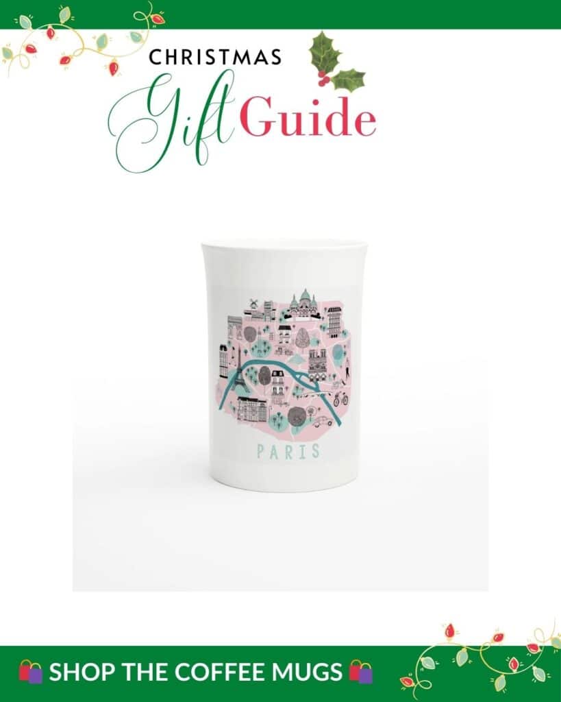 A white mug decorated with a whimsical, pastel map-style design of Paris, featuring iconic landmarks, trees, and the Seine River. The "Shop the Coffee Mugs" banner suggests these are perfect gifts for Francophiles.