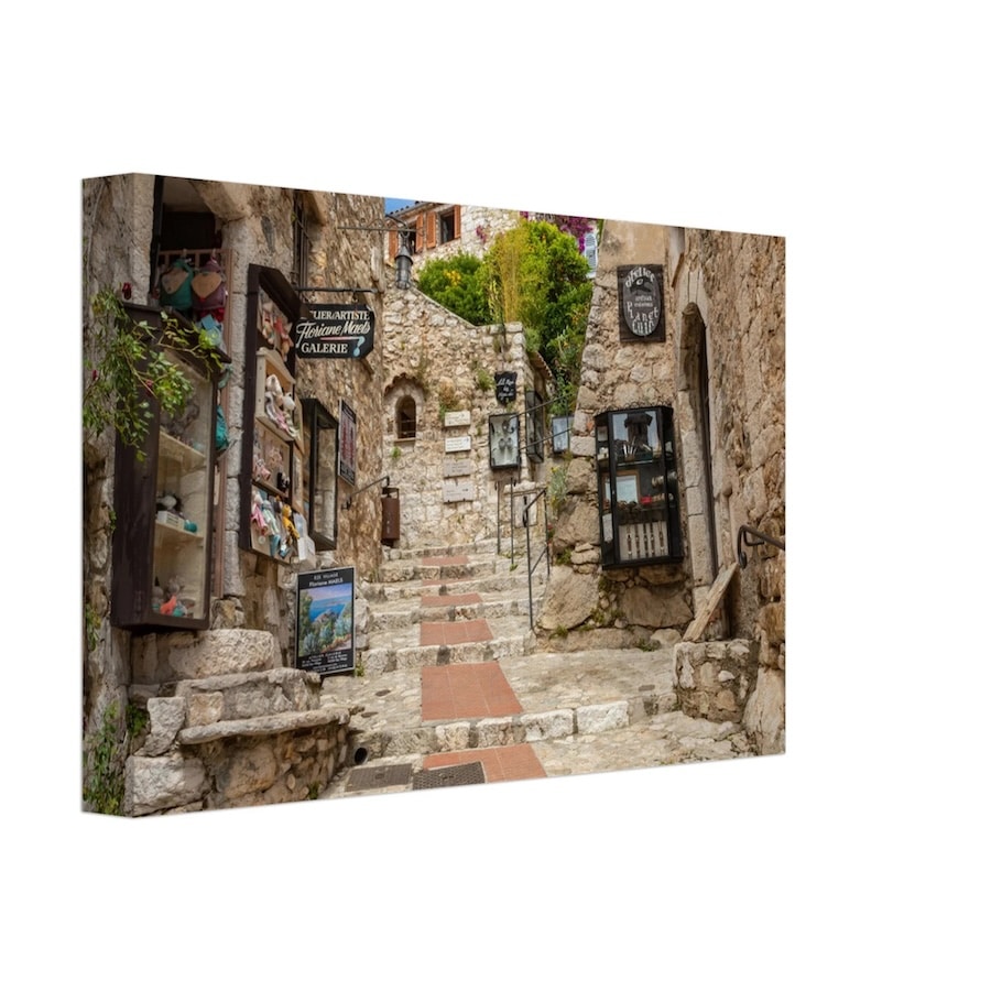 A canvas print of a charming stone pathway in the village of Èze on the French Riviera, lined with small artisan shops and galleries, capturing the rustic beauty and timeless appeal of this historic town.