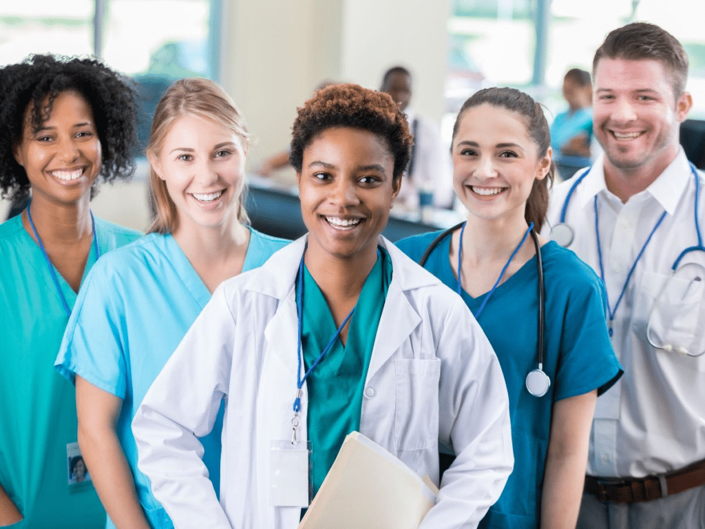 A diverse group of smiling healthcare professionals, representing the quality and accessibility of healthcare that attracts Americans moving to France. This welcoming healthcare environment reflects France's commitment to high standards in medical care.